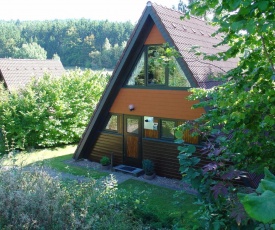 Detached, wooden bungalow with a terrace, in a wooded area