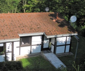 Detached, wooden bungalow, in a green wooded area